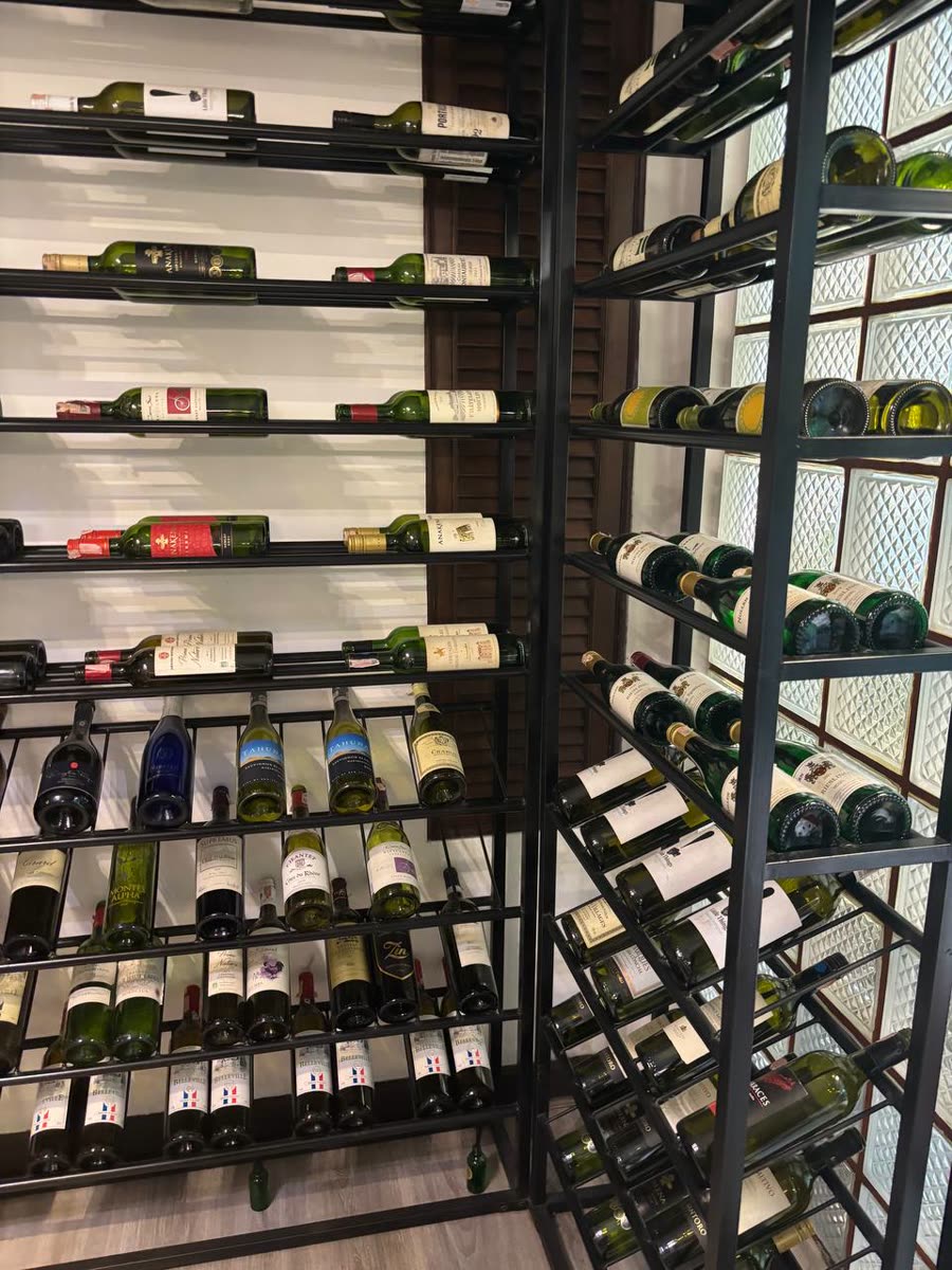 Wine bottles on black metal racks